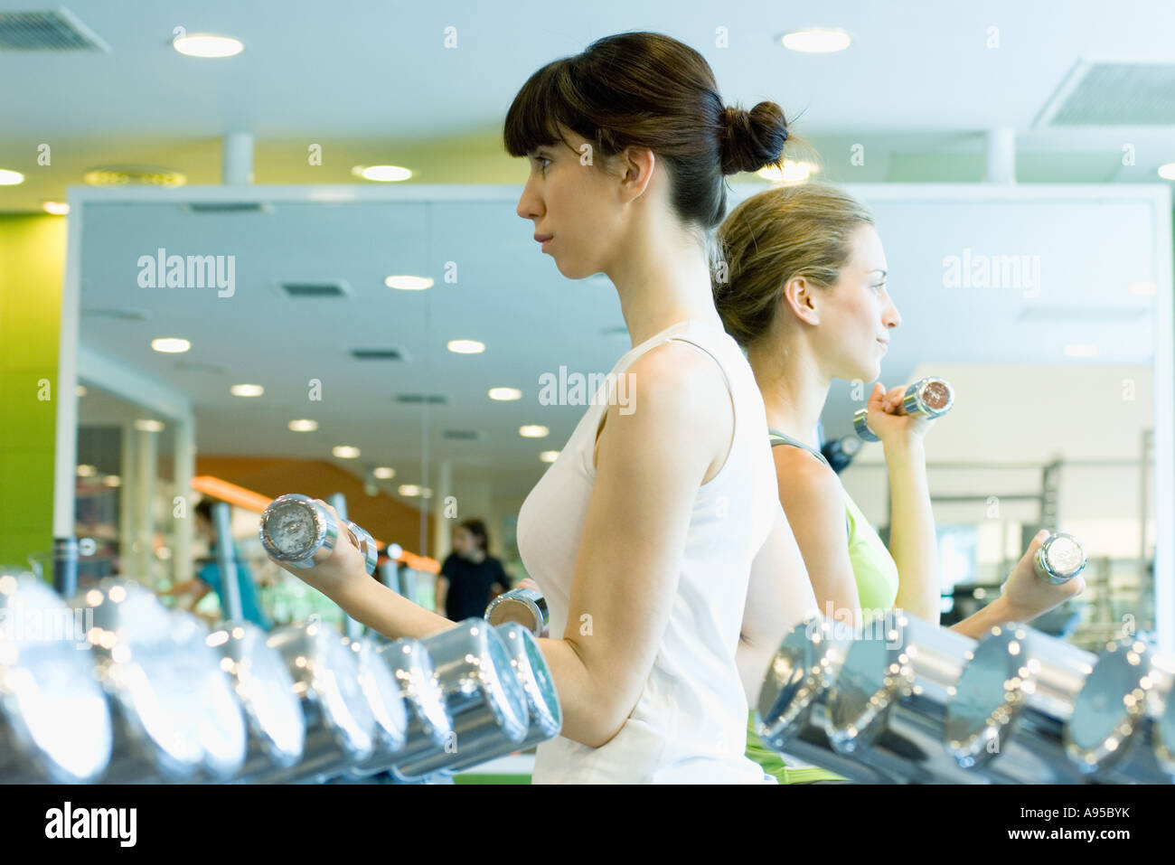 Two women working out with dumbbells Stock Photo