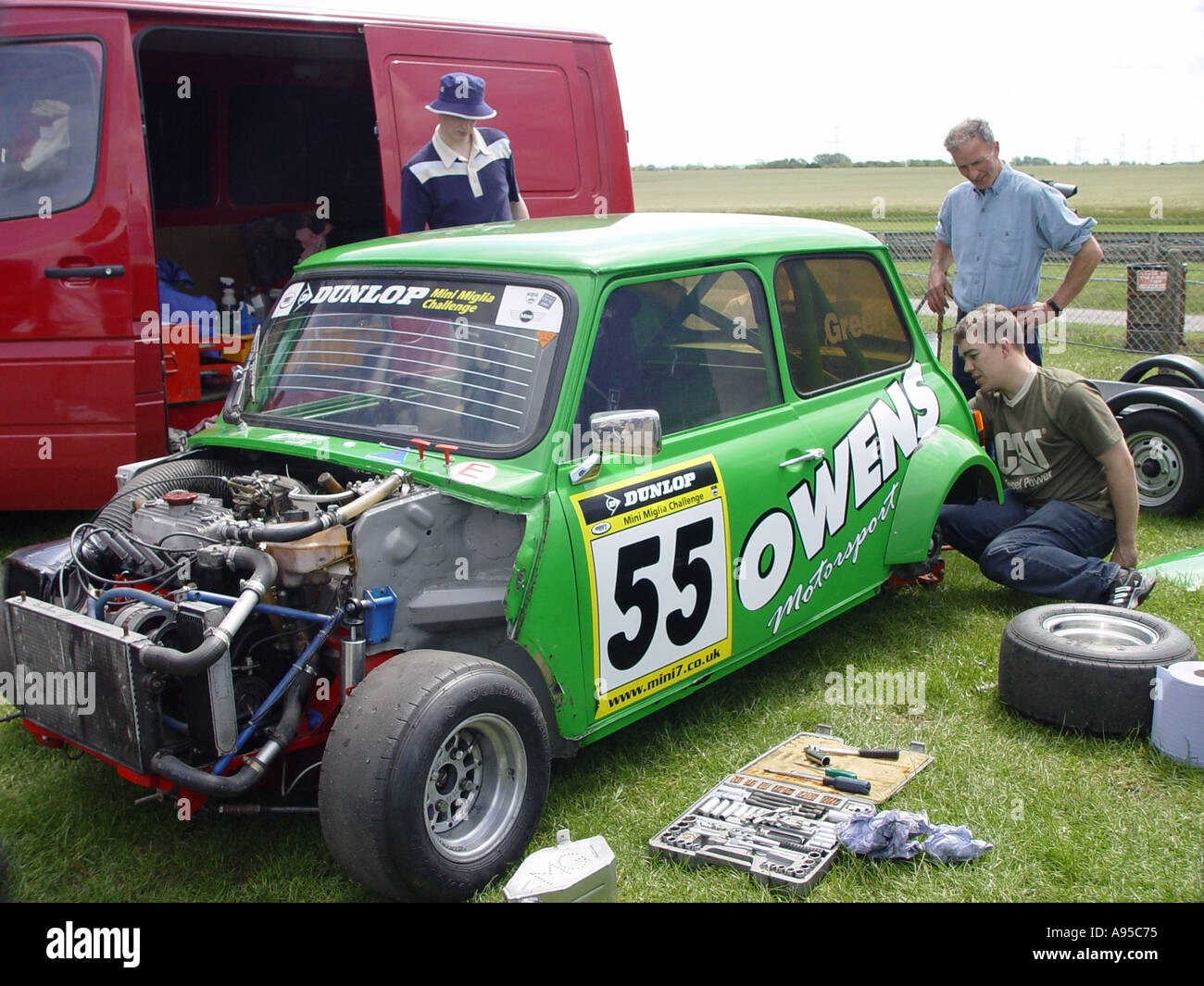 Mechanics working on a Mini at the motor racing circuit near the village of Castle Combe Wiltshire England GB UK 2003 Stock Photo