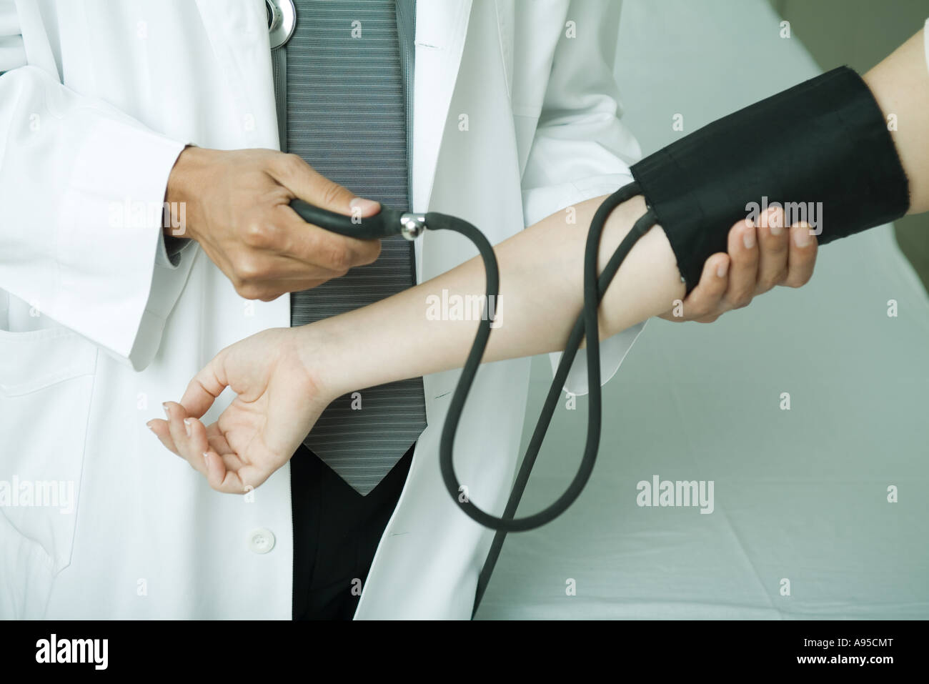 Doctor taking patient's blood pressure Stock Photo Alamy