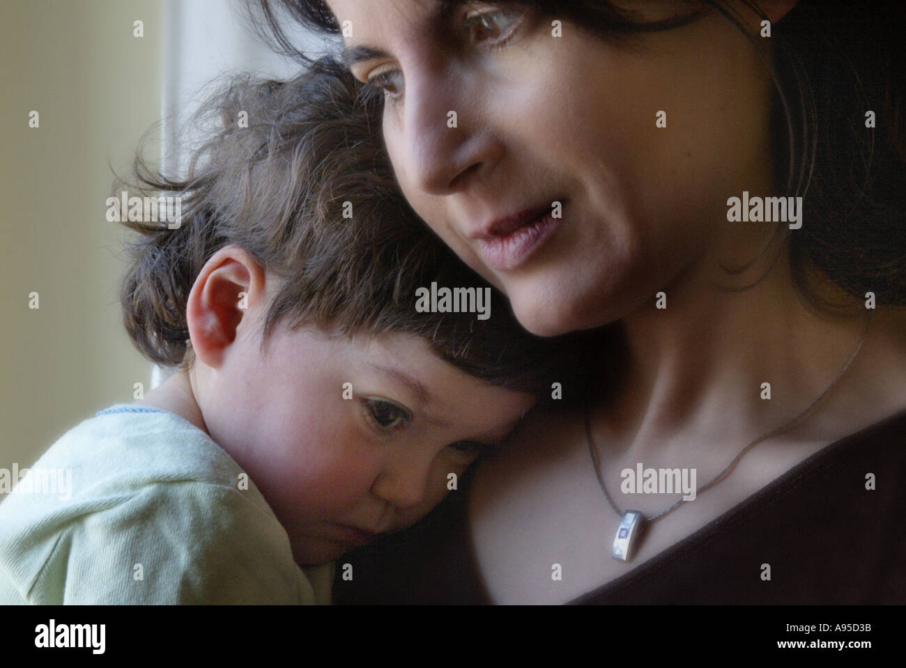 A litle girl waking up with her mother Stock Photo