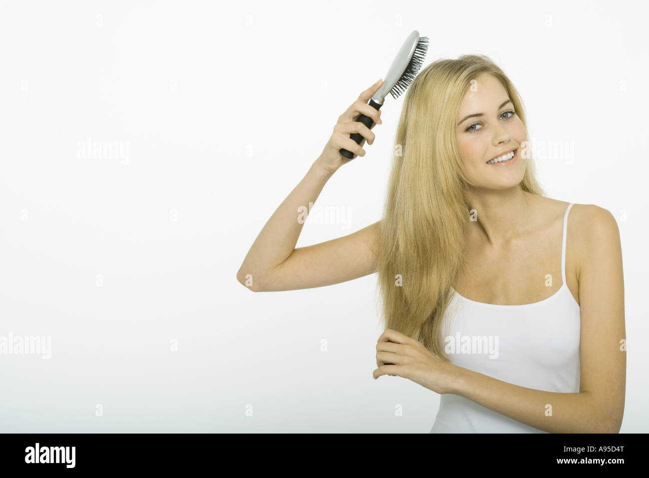 Teenage girl brushing hair Stock Photo