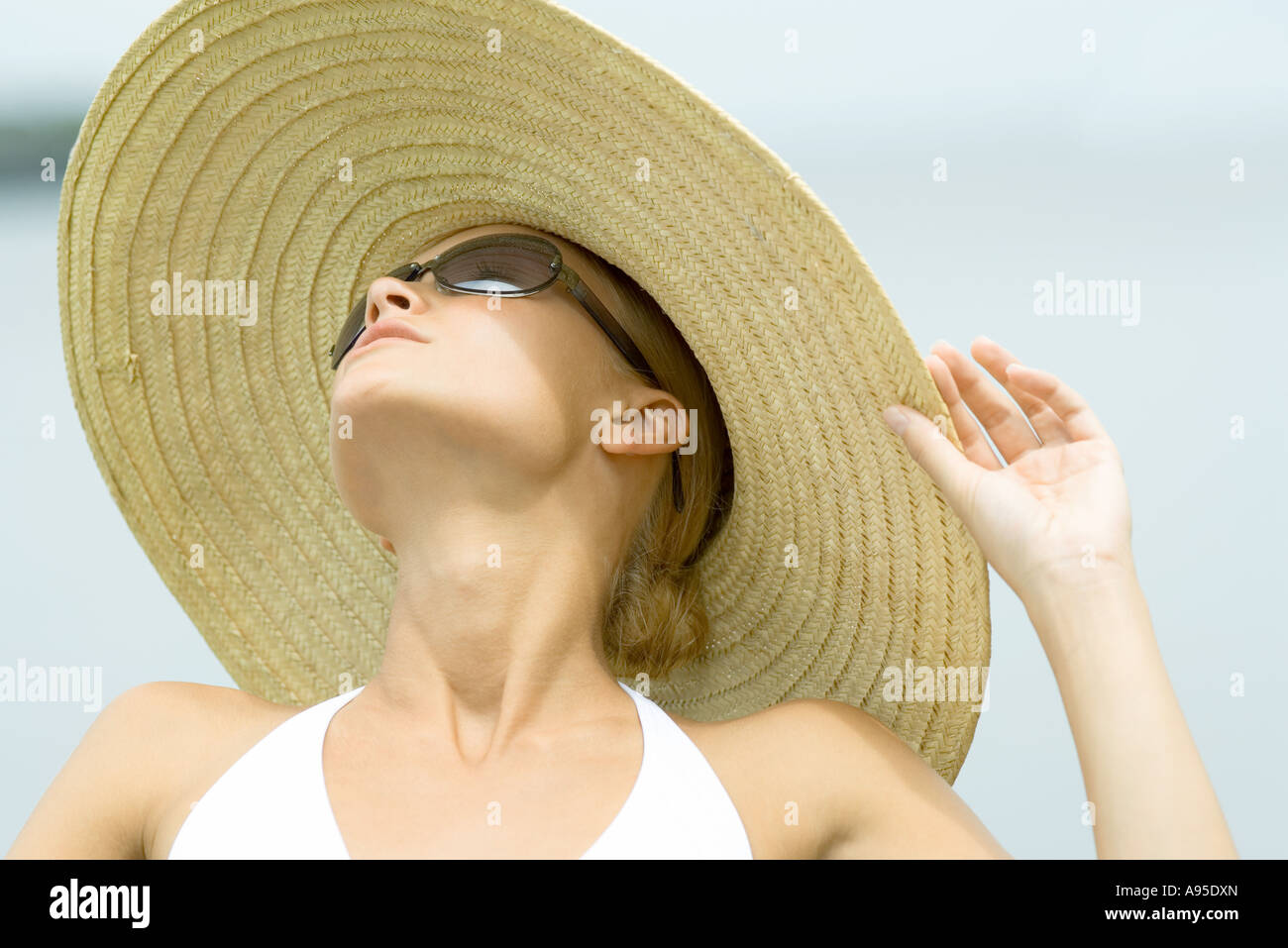 Young Woman Wearing Sunglasses And Sunhat Head And Shoulders Stock