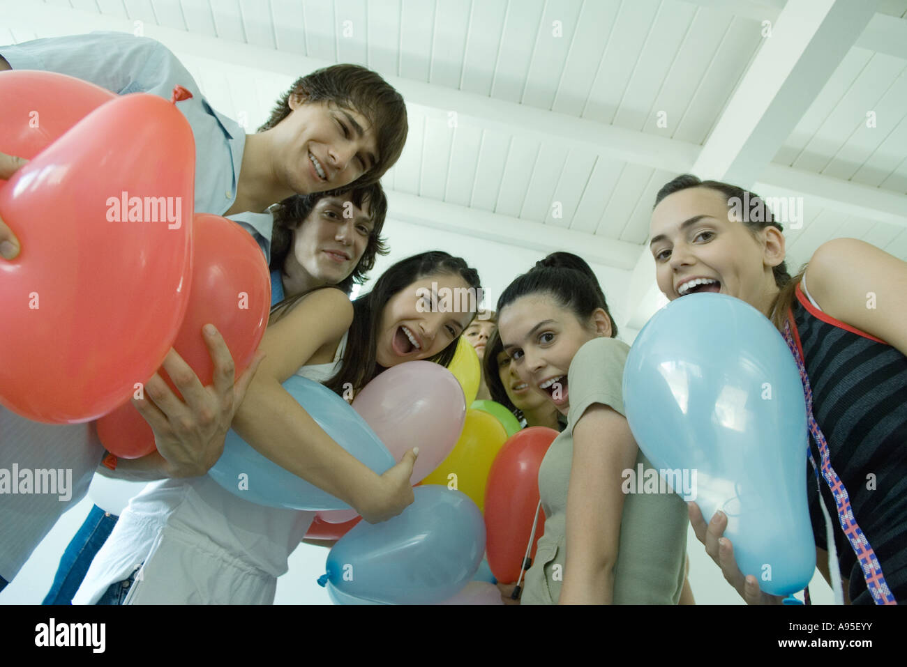 Teenage friends holding balloons Stock Photo