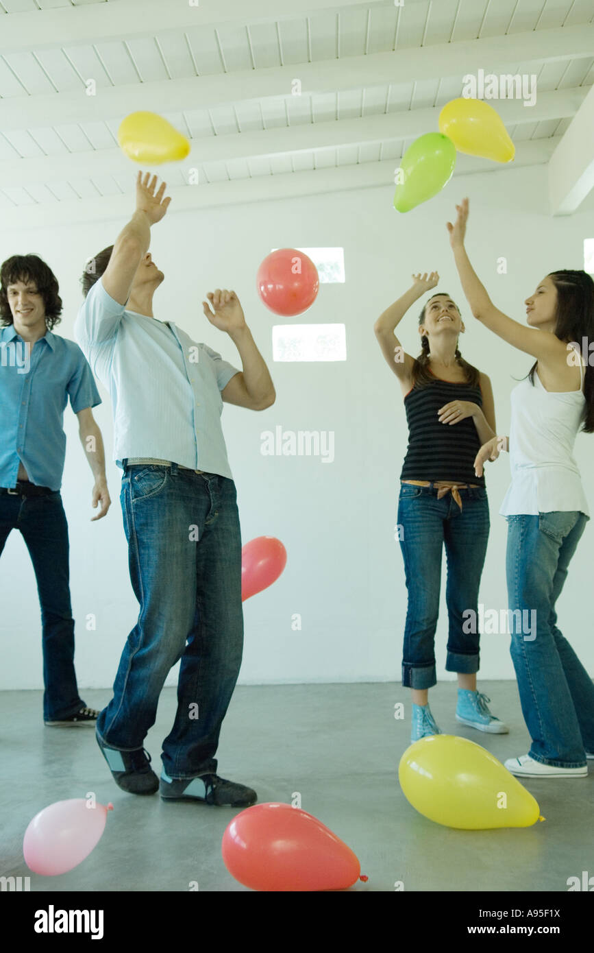 Teenage friends playing with balloons Stock Photo
