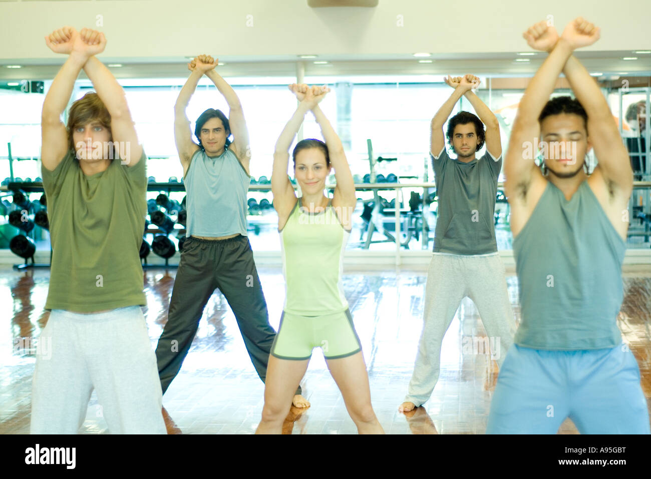 Exercise class standing with arms crossed over head Stock Photo Alamy