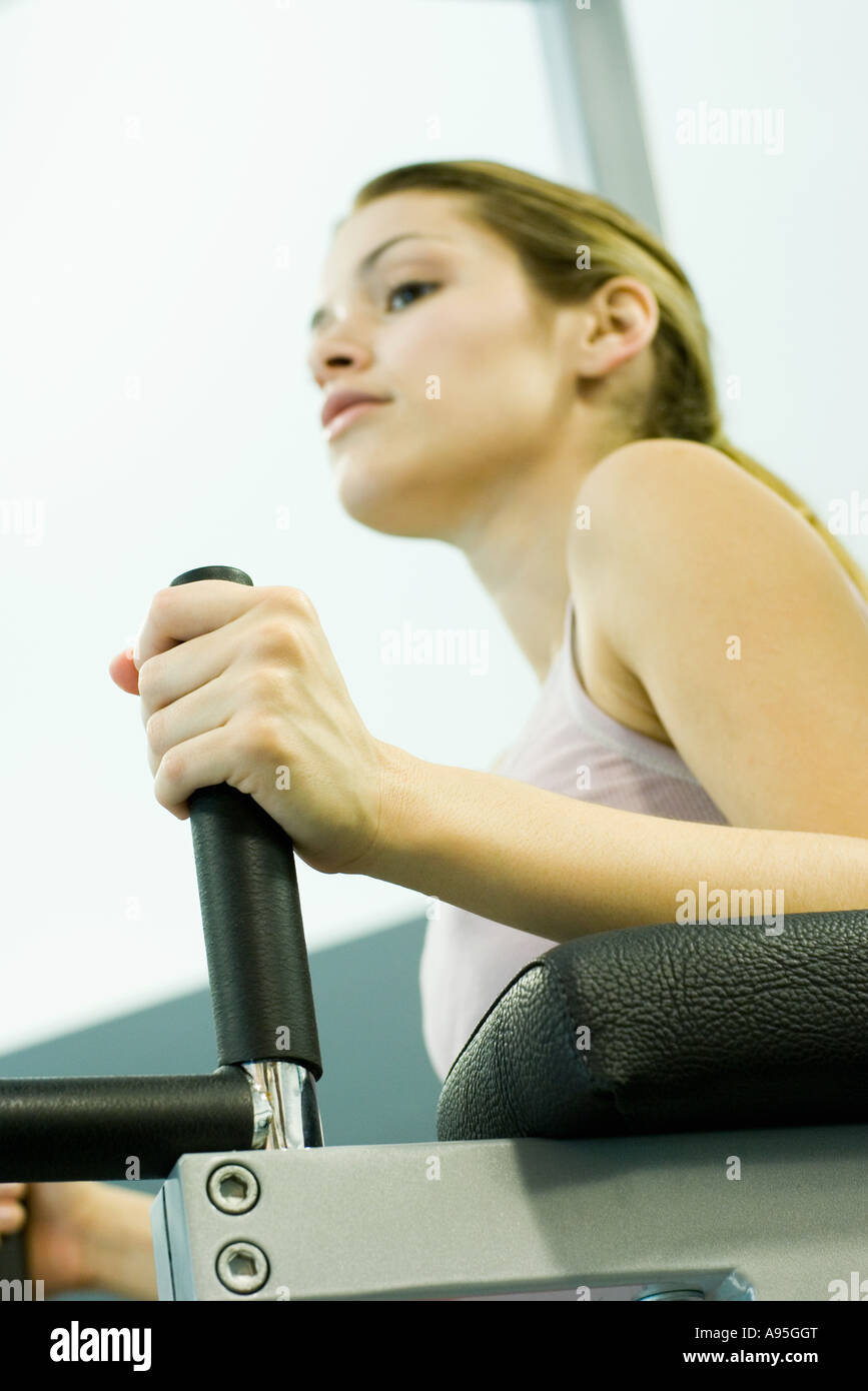 Woman using weight machine Stock Photo Alamy