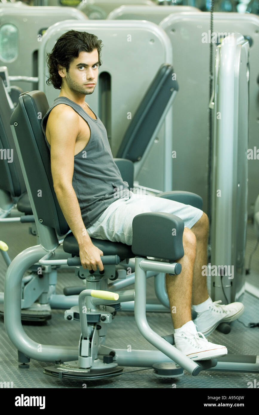 Man working out on weight machine Stock Photo