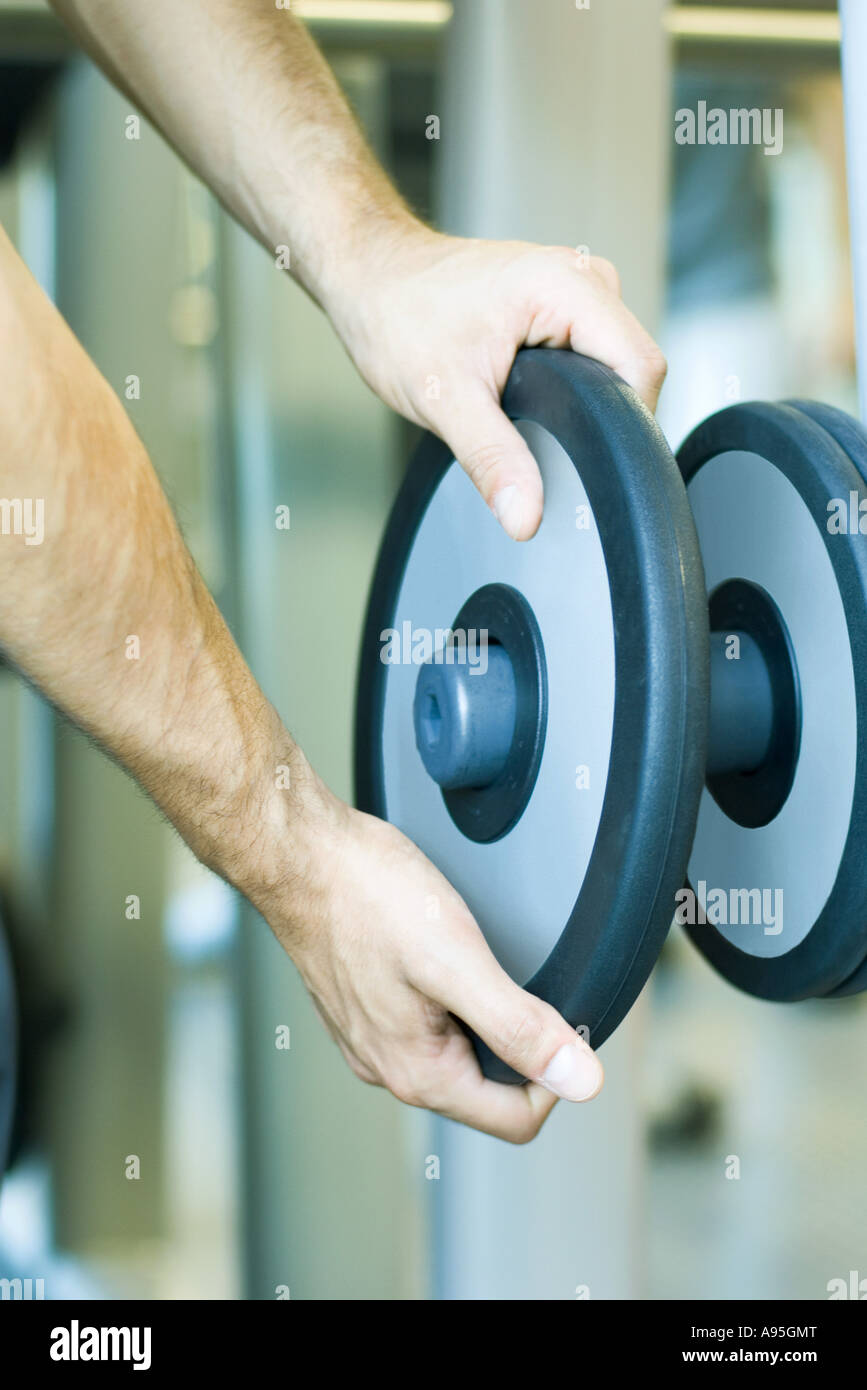 Man taking weight from rack Stock Photo
