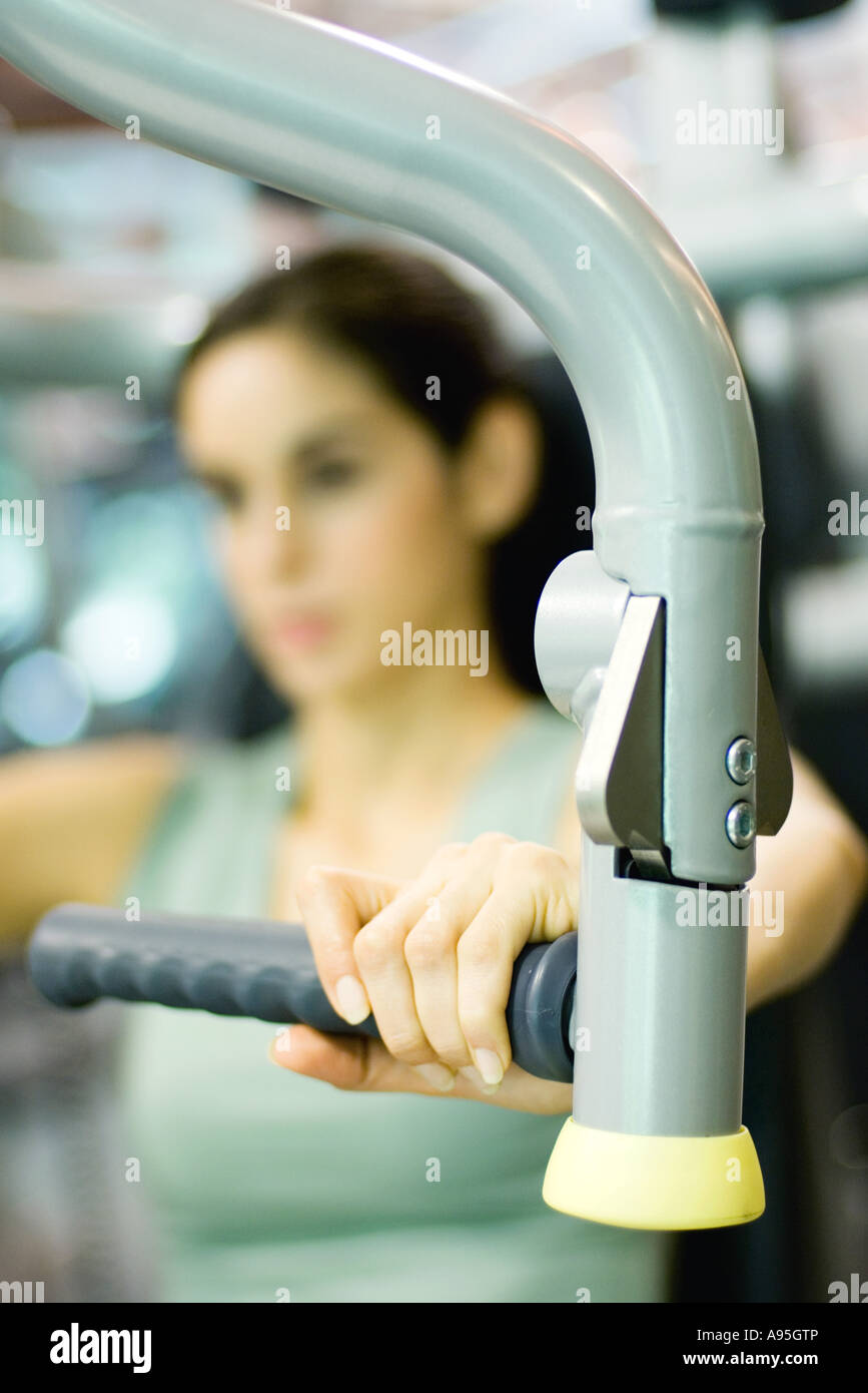 Woman working out with weight machine Stock Photo