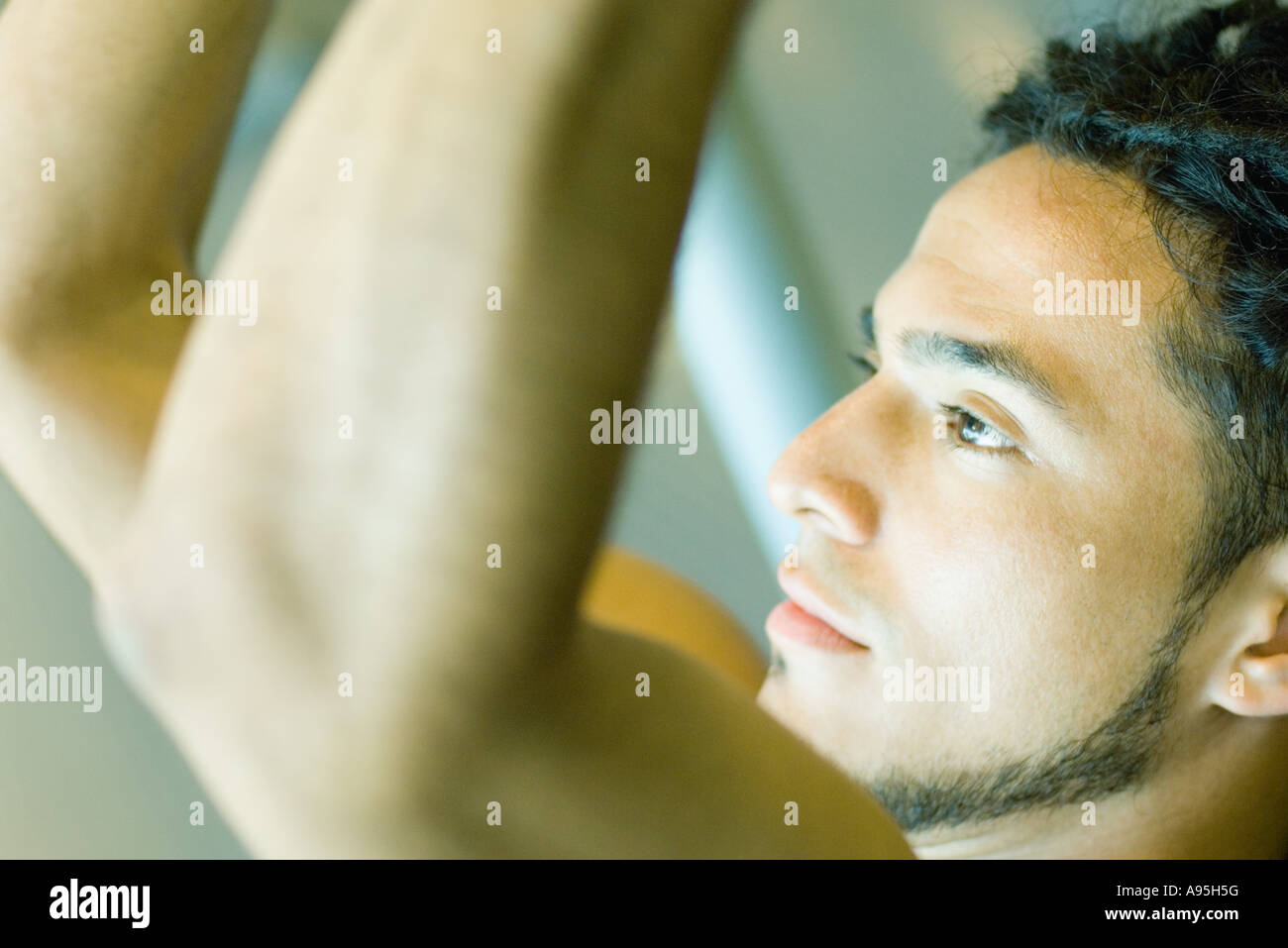 Man lifting weights, close-up, side view Stock Photo