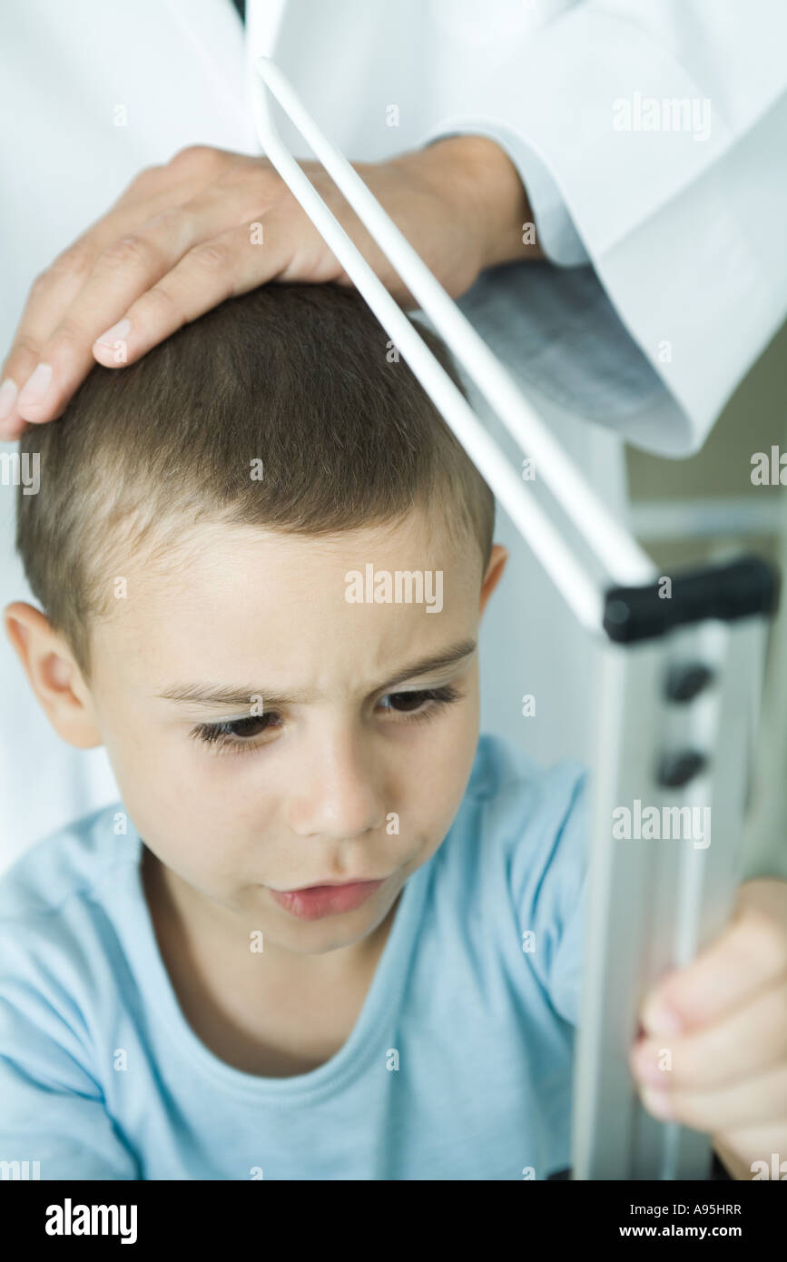 Doctor measuring boy during check-up Stock Photo