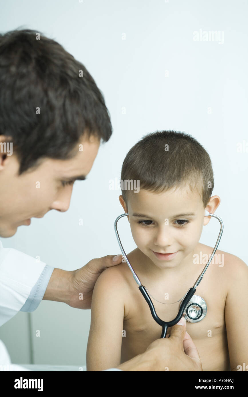 Doctor letting boy listen to own chest with stethoscope Stock Photo Alamy