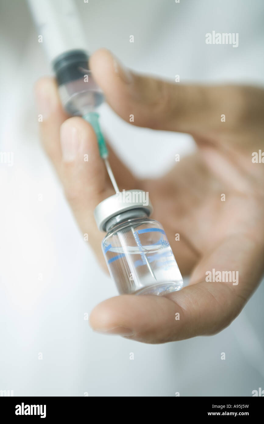 Doctor filling syringe from bottle Stock Photo Alamy