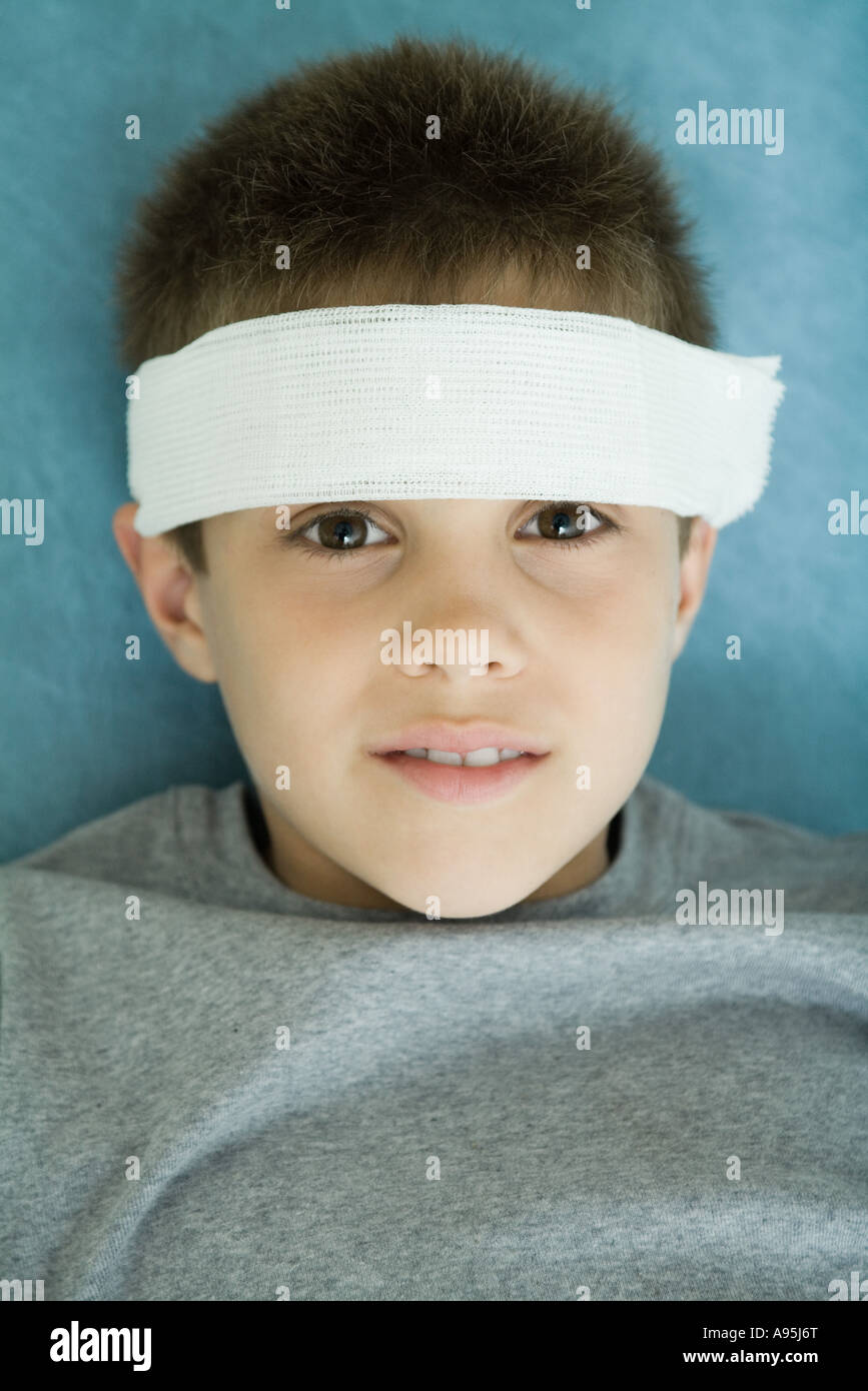 Boy with bandage on forehead, portrait, looking at camera Stock Photo
