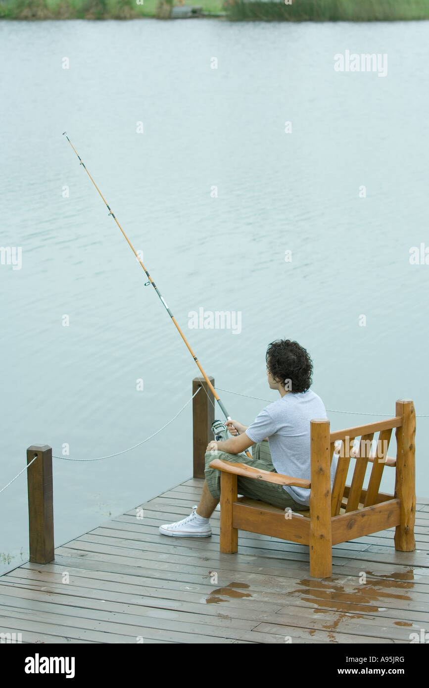 Young man fishing on dock hi-res stock photography and images - Alamy