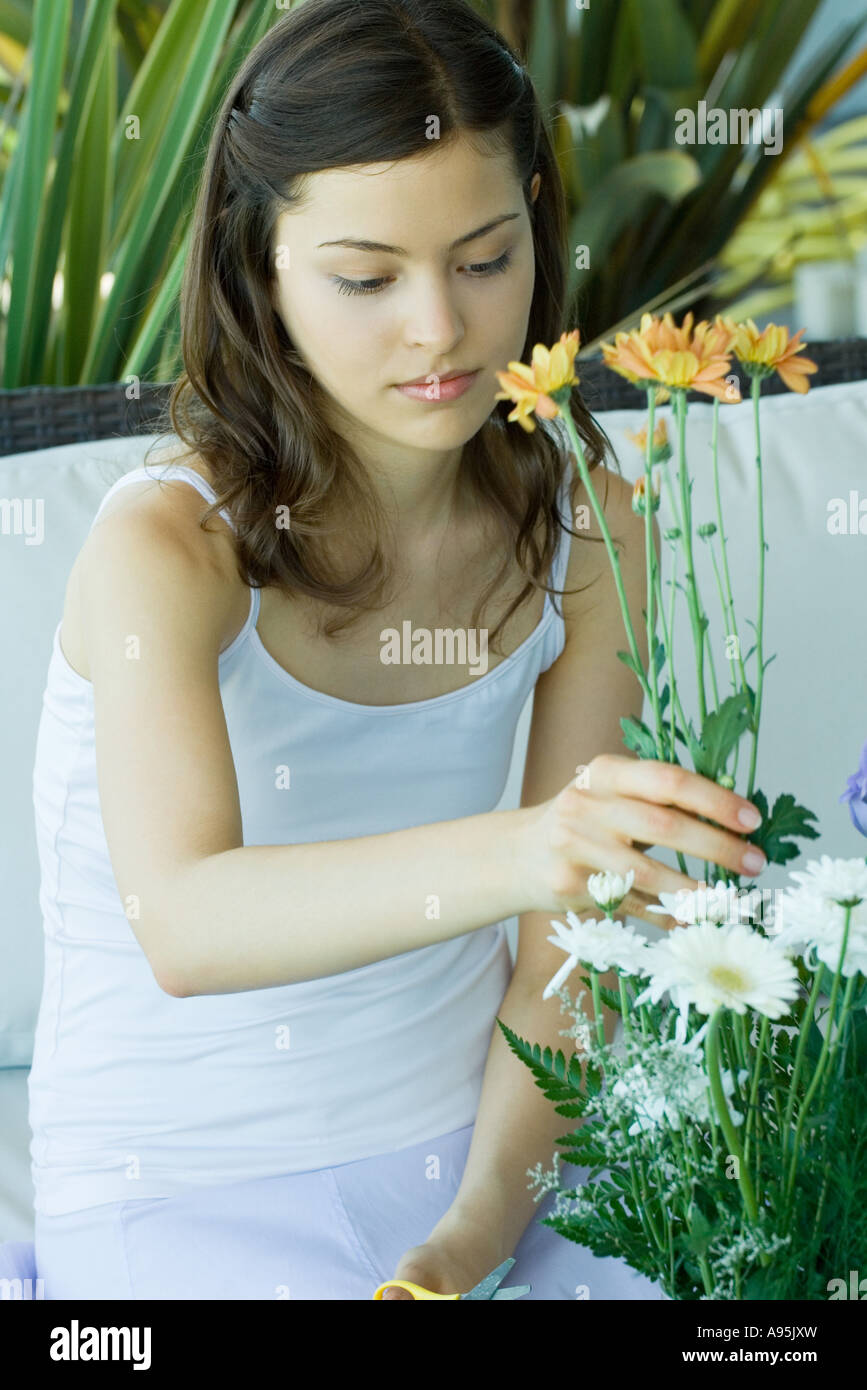 Young woman making fresh flower arrangement Stock Photo - Alamy