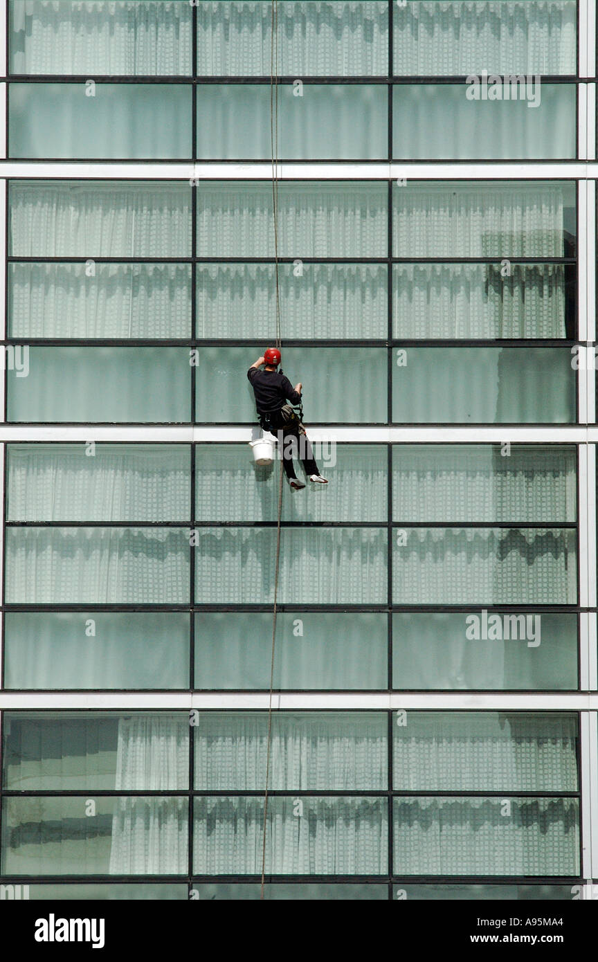 Window cleaner on rope pulley system cleaning Lowry Hotel windows Stock  Photo - Alamy