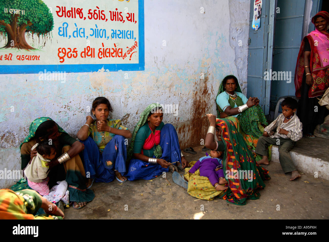 Tribal Indian Women relaxing in quiet corner in Anjar, Kutch, Gujarat, India Stock Photo
