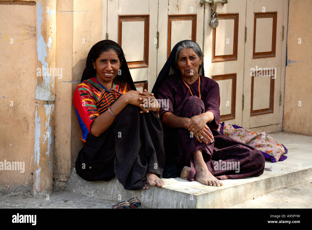 Two Indian women posing in doorway, Anjar, Kutch, Gujarat, India Stock Photo