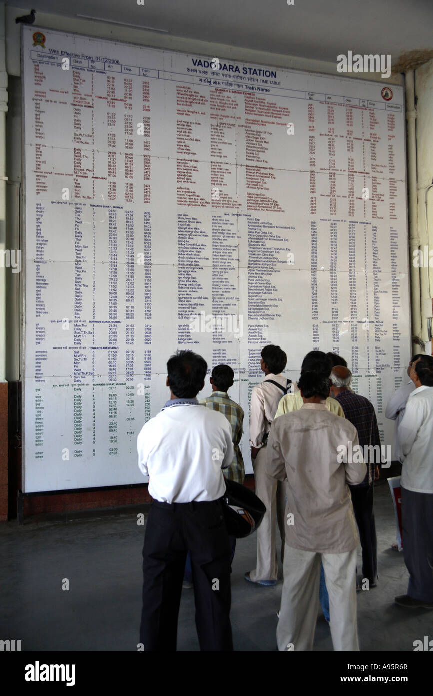 Indian passengers checking railway timetable at Vadodara Station