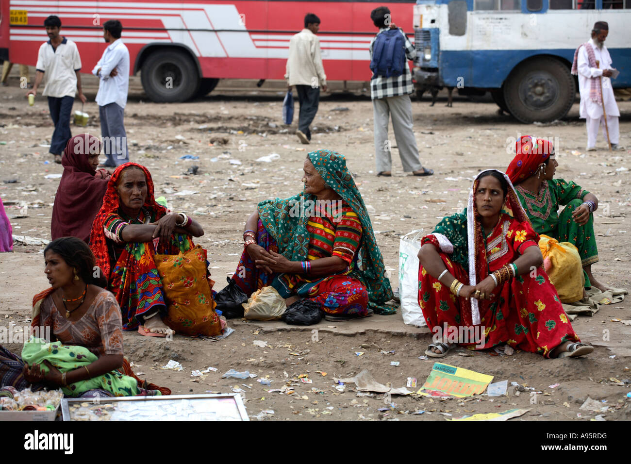 Tribal Indian women from Kutch district seated on ground waiting at bus station, Bhuj, Gujarat, India Stock Photo