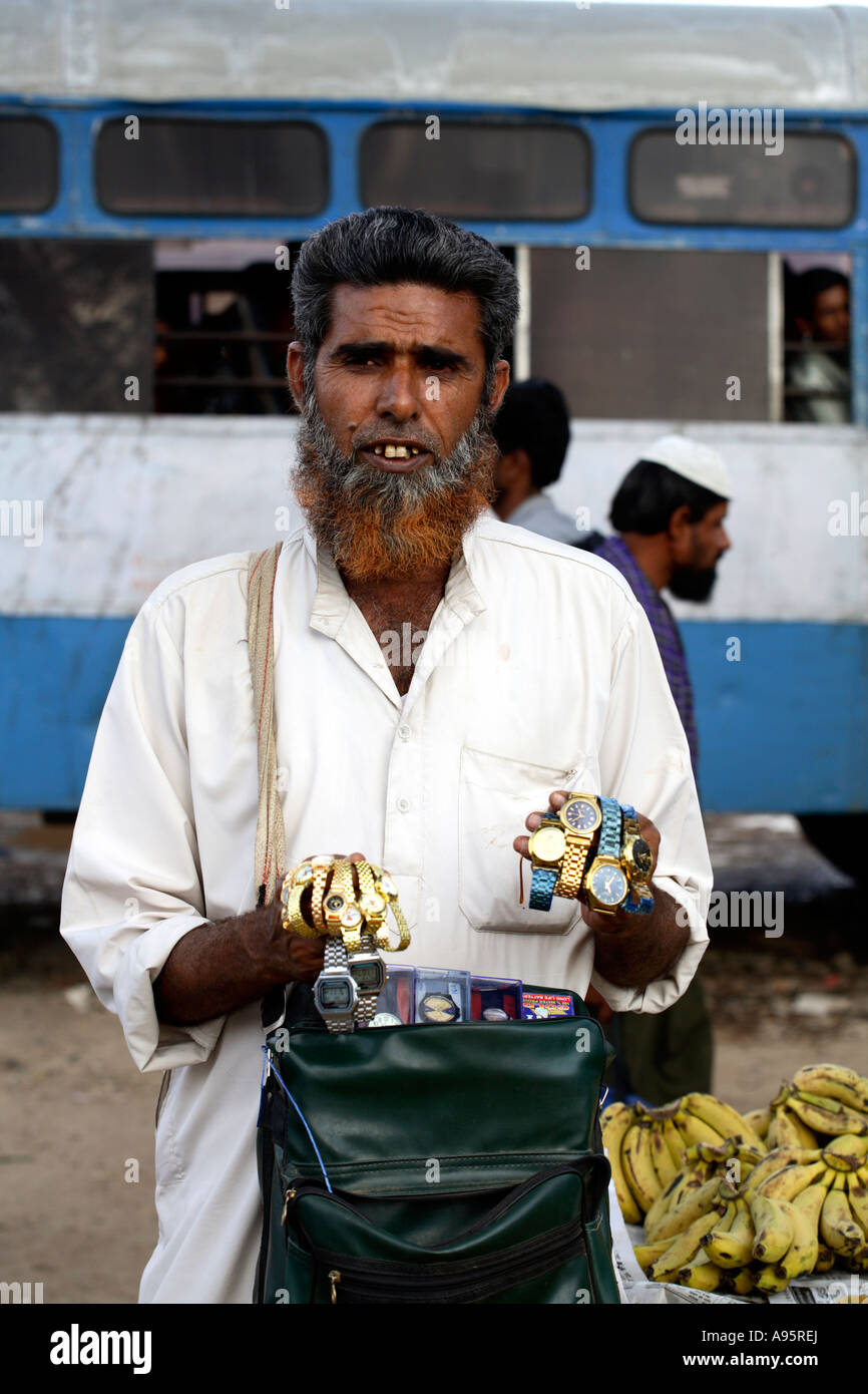 Male Indian hawker selling watches at Bhuj Bus Stand, Gujarat, India Stock Photo