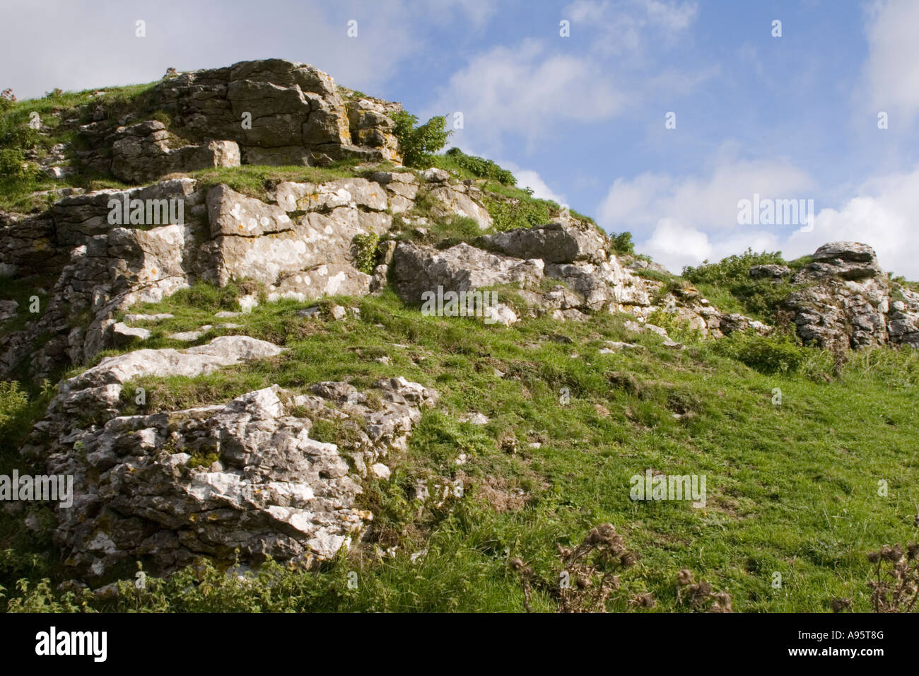 Limestone rocks set against a blue sky overlooking the Winnats Pass near Castleton in Derbyshire. Stock Photo