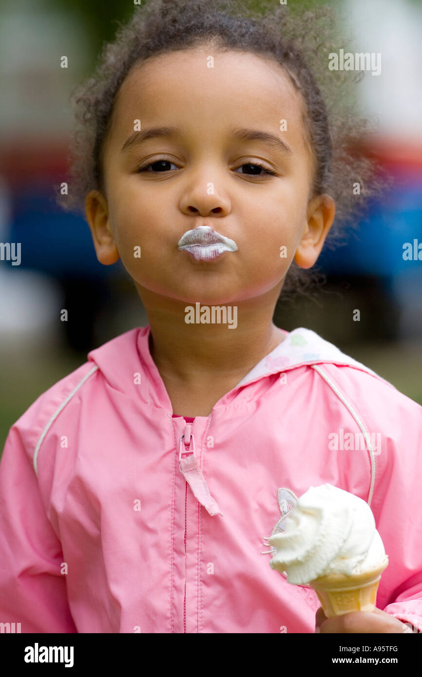 A Beautiful Mixed Race Little Girl Eating An Ice Cream And Blowing A Kiss To The Camera Stock Photo Alamy