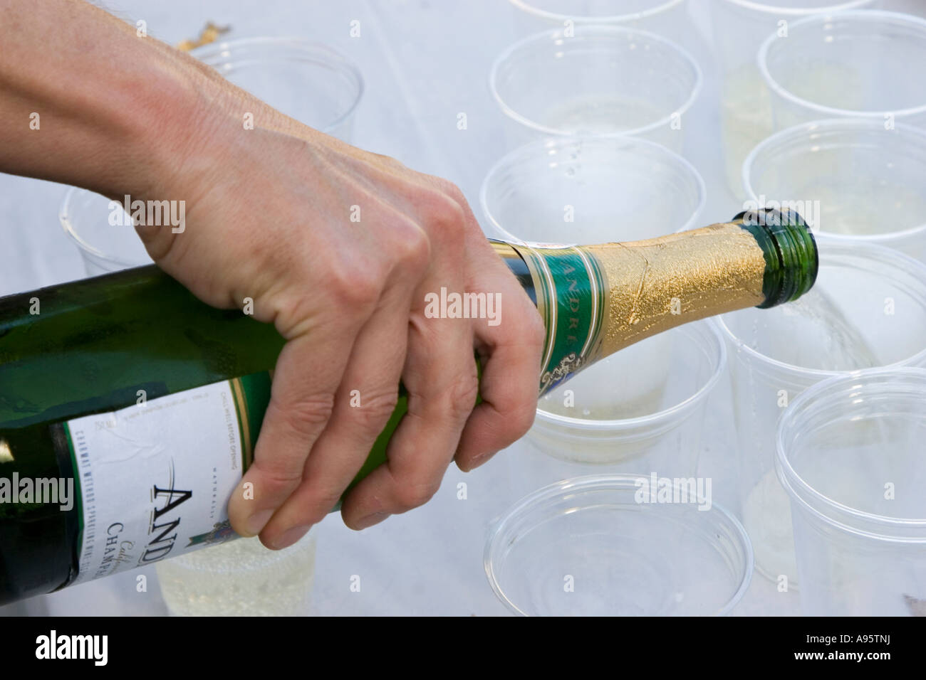 Detroit Michigan Champagne being poured from a bottle into plastic cups Stock Photo