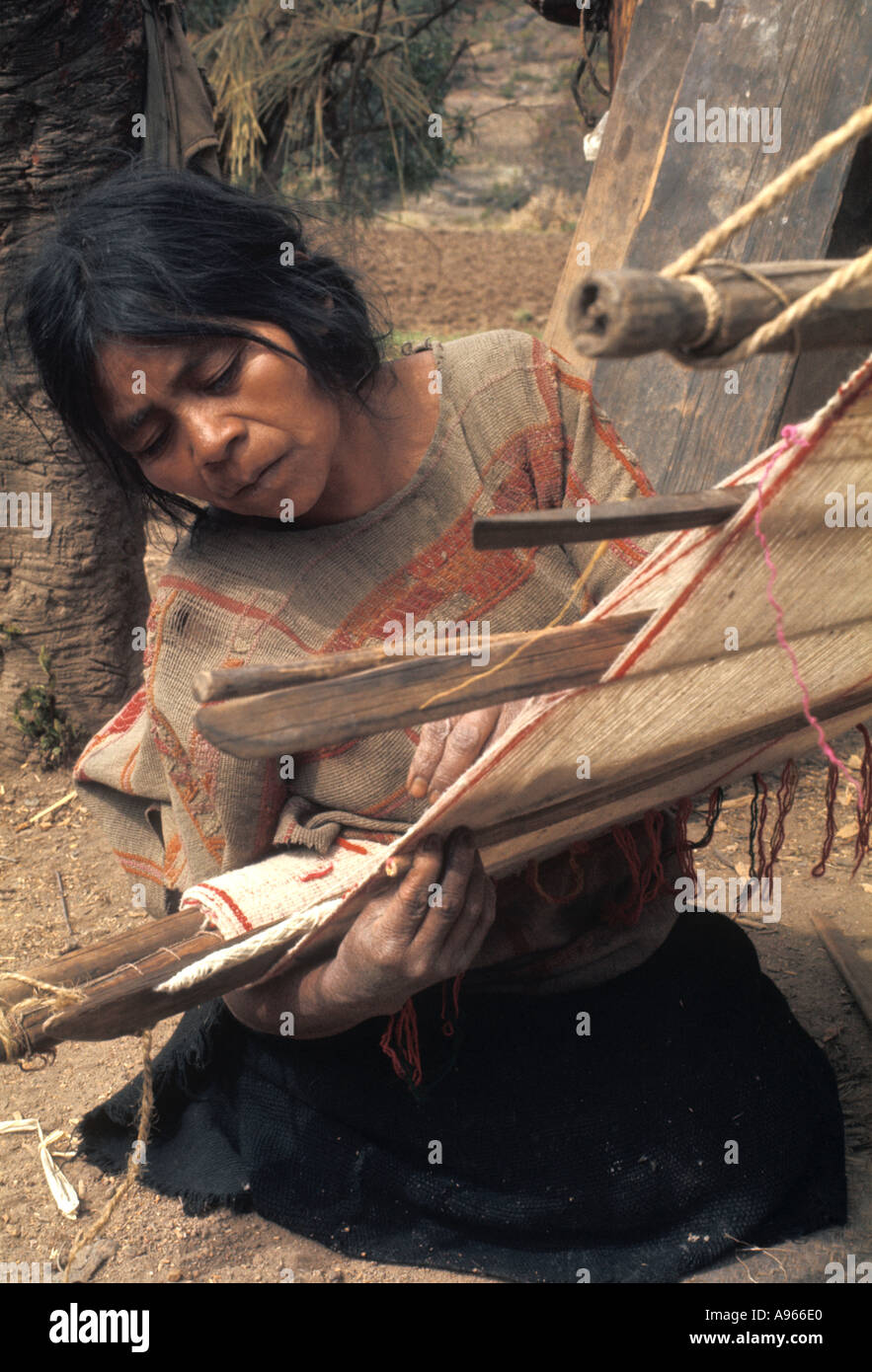 Mexico Oaxaca State. Indian woman of Mixtec ethnic group weaving using ...