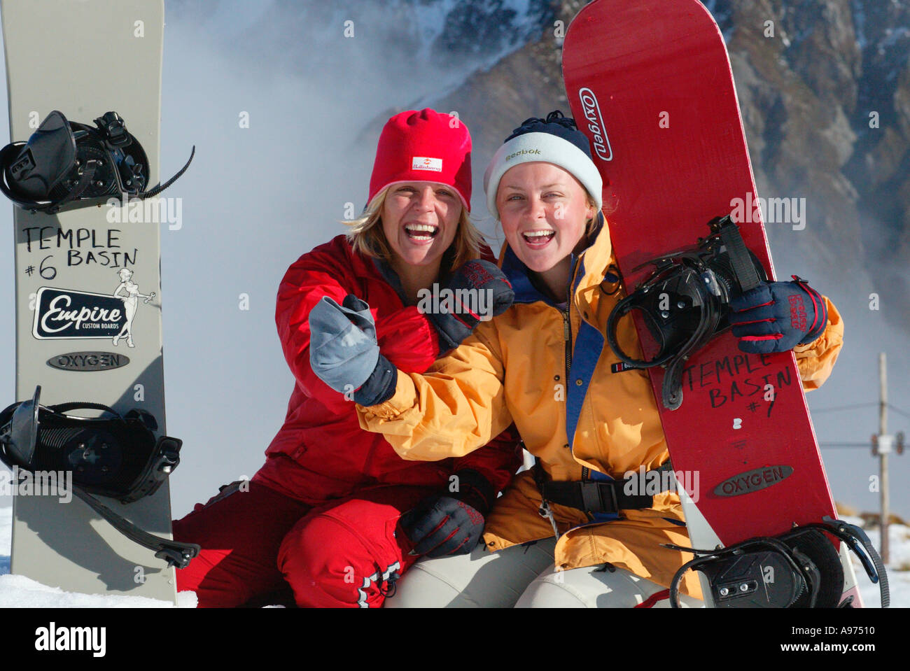 Sisters with snowboards learning to snowboard in New Zealand Stock Photo