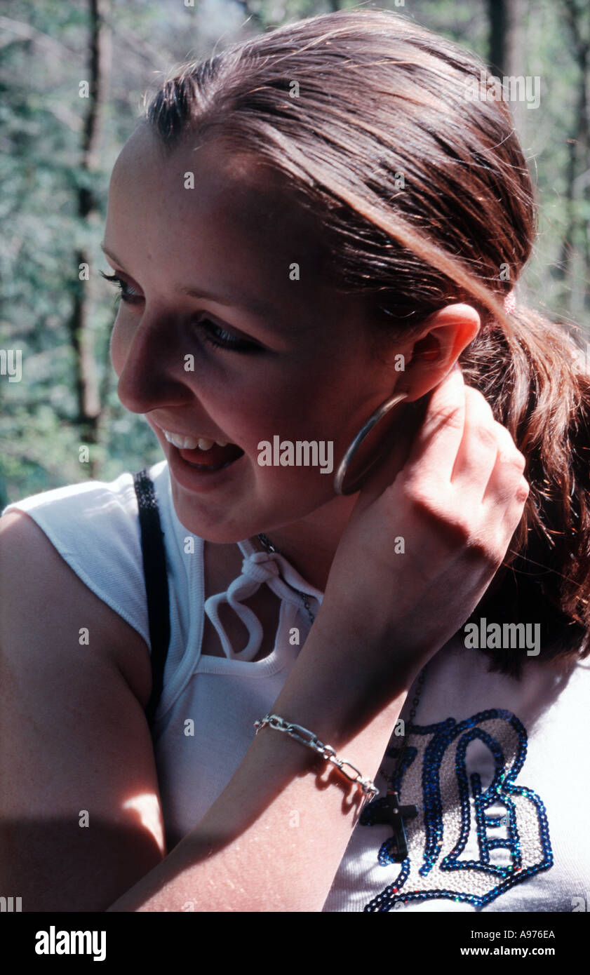Happy teenage girl with hoop earring Stock Photo