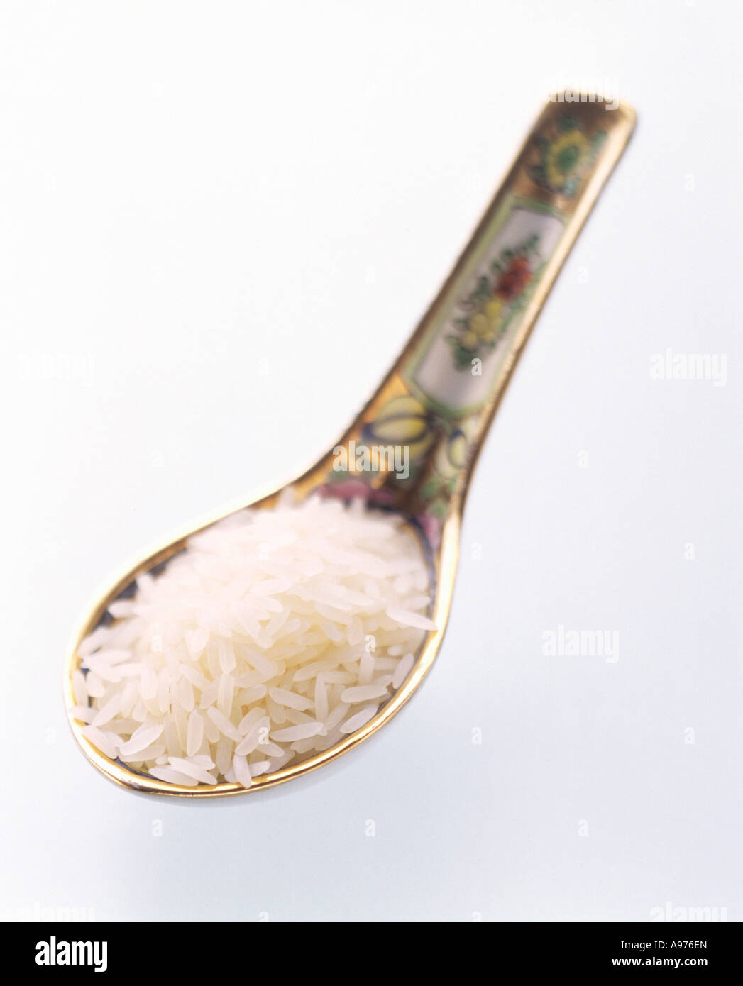 A Spoonful of Uncooked Long Grain White Rice FoodCollection Stock Photo