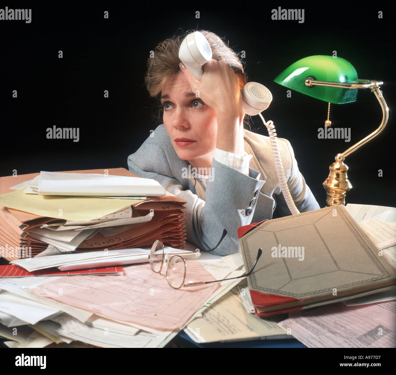 woman accountant overwhelmed from too much paperwork Stock Photo