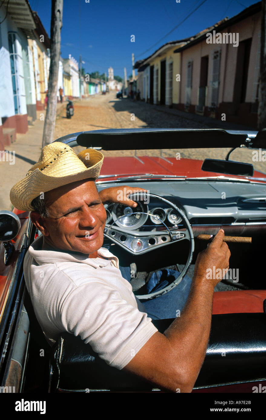 Man in vintage American car Cuba Caribbean Stock Photo