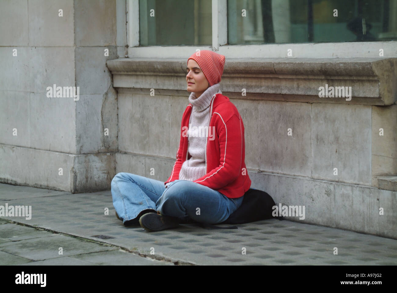 Buddhist taking time to meditate outside India House, London Stock Photo