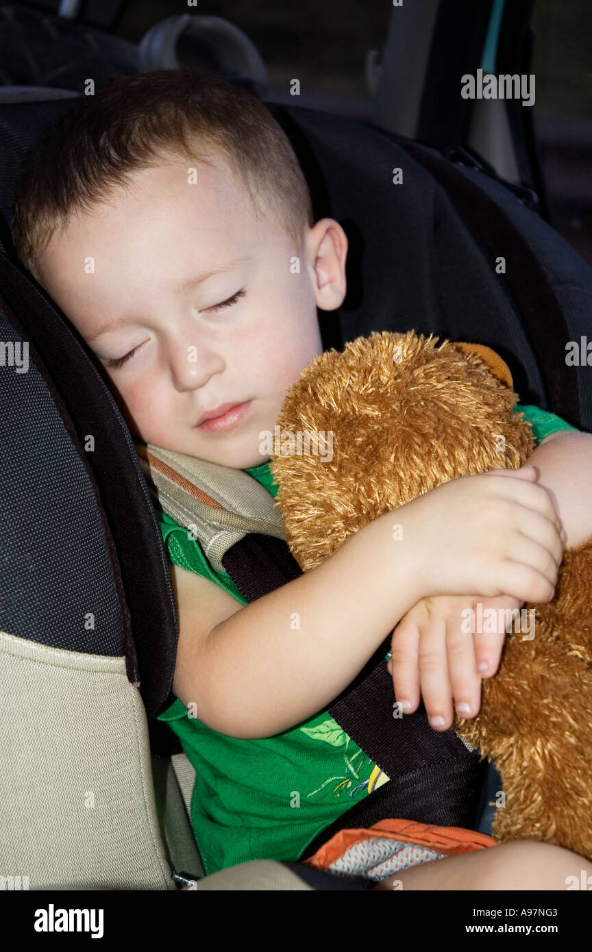 BOY SLEEPING IN CAR SEAT Stock Photo