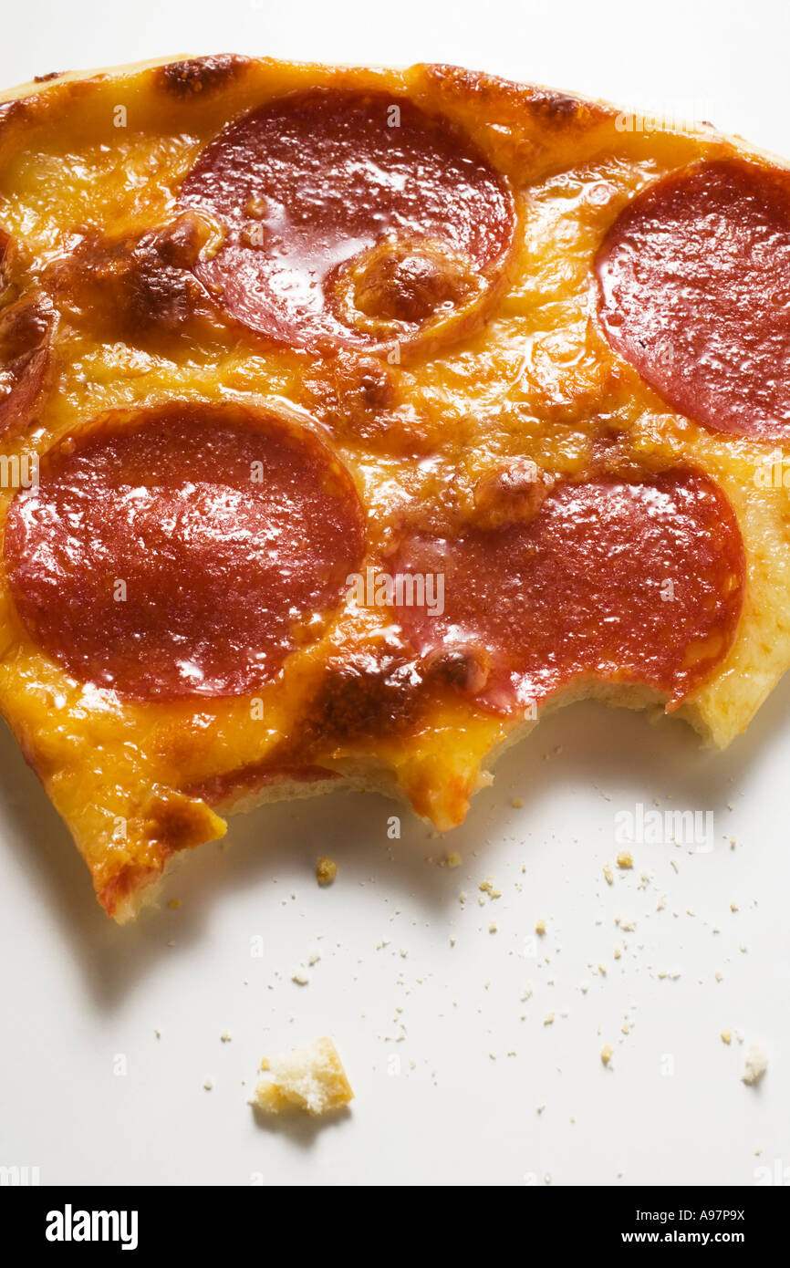 Piece of salami and cheese pizza bites taken FoodCollection Stock Photo