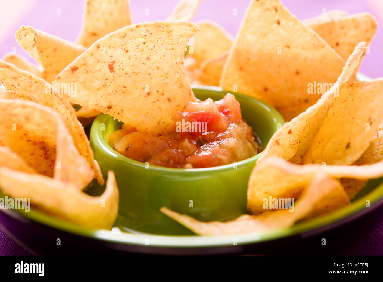Tortilla chip dipped in tomato salsa FoodCollection Stock Photo Alamy