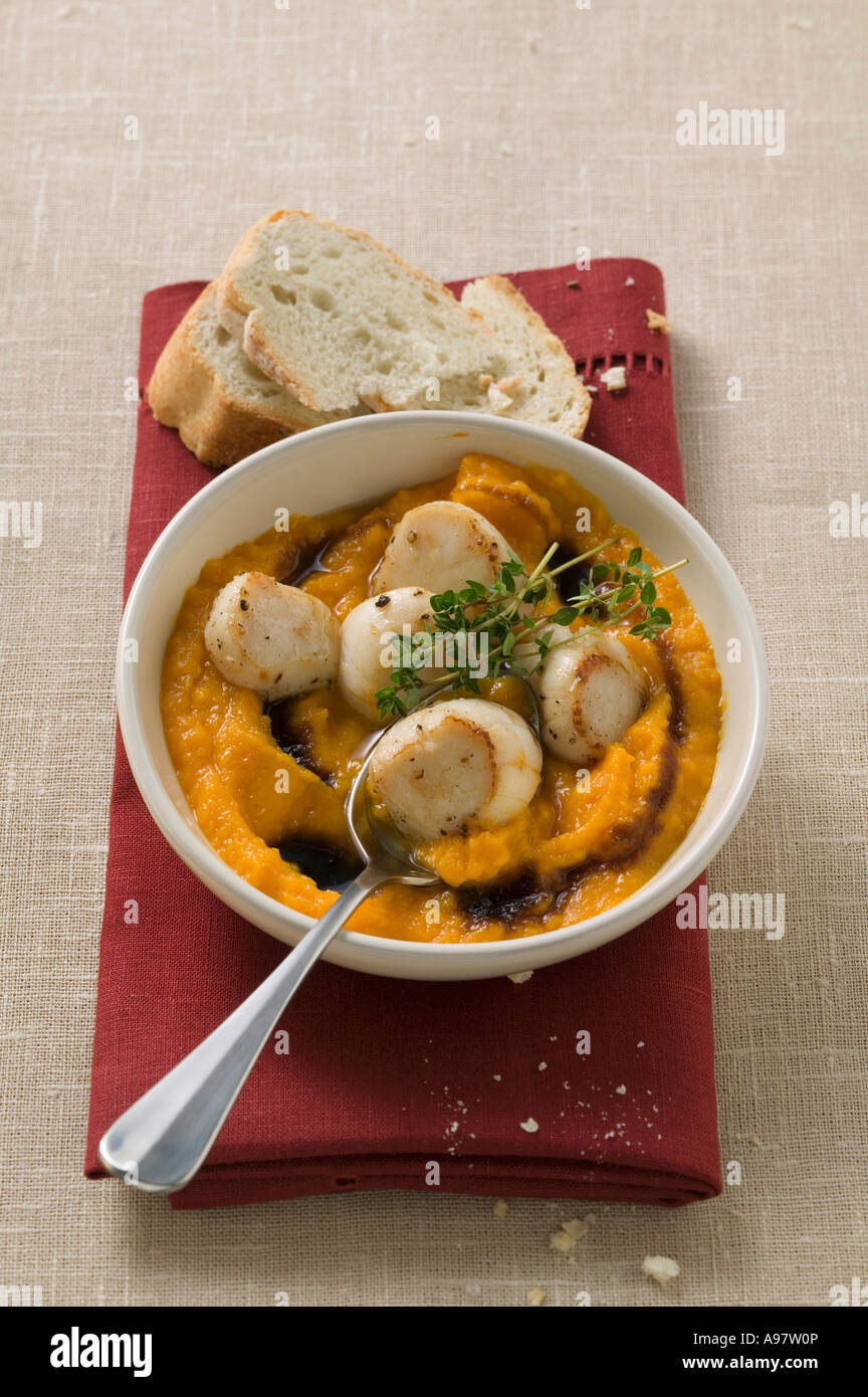 Scallops with pumpkin puree and thyme white bread FoodCollection Stock