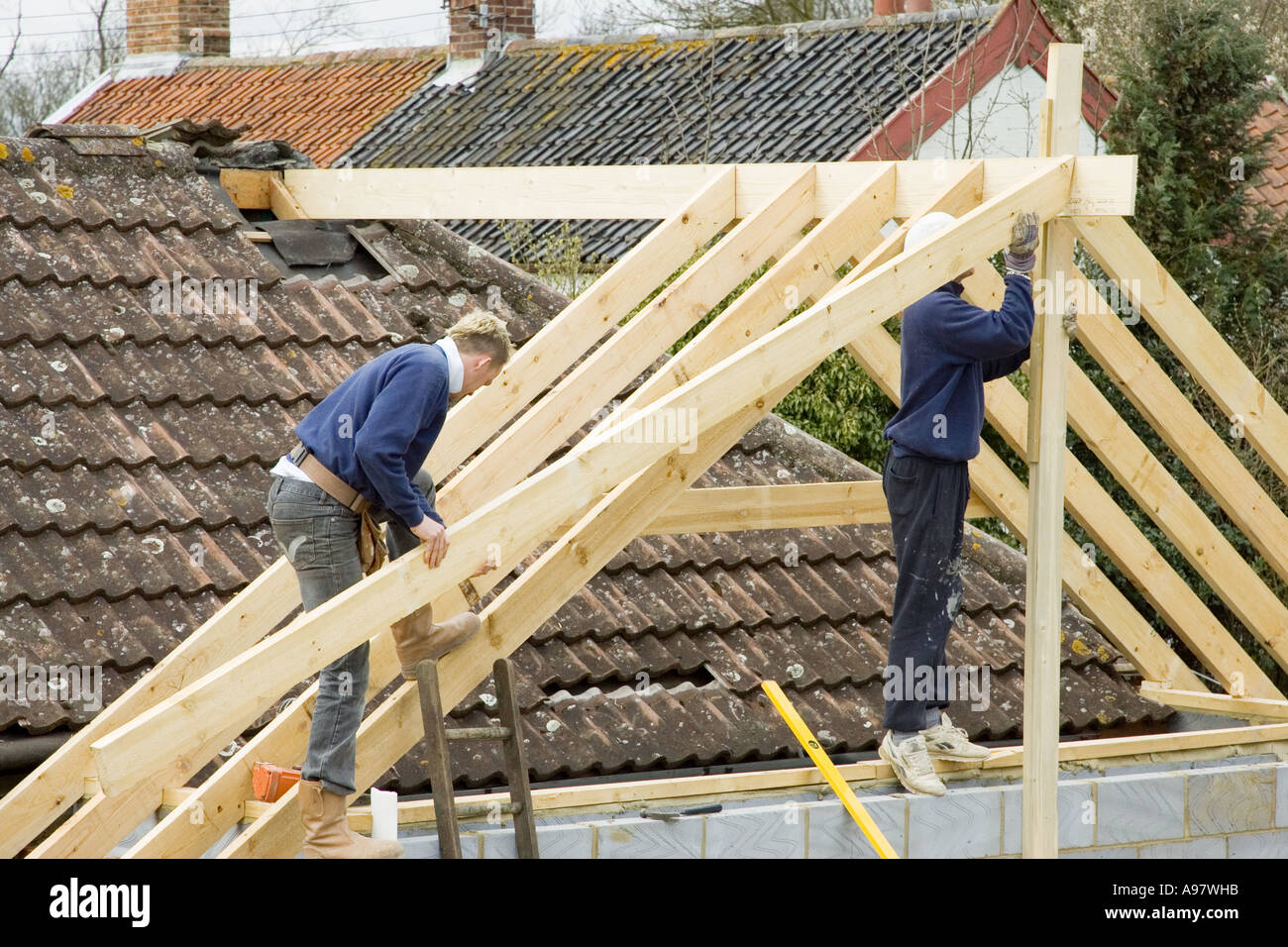 builders constructing a new roof for an extension to a home Stock Photo ...