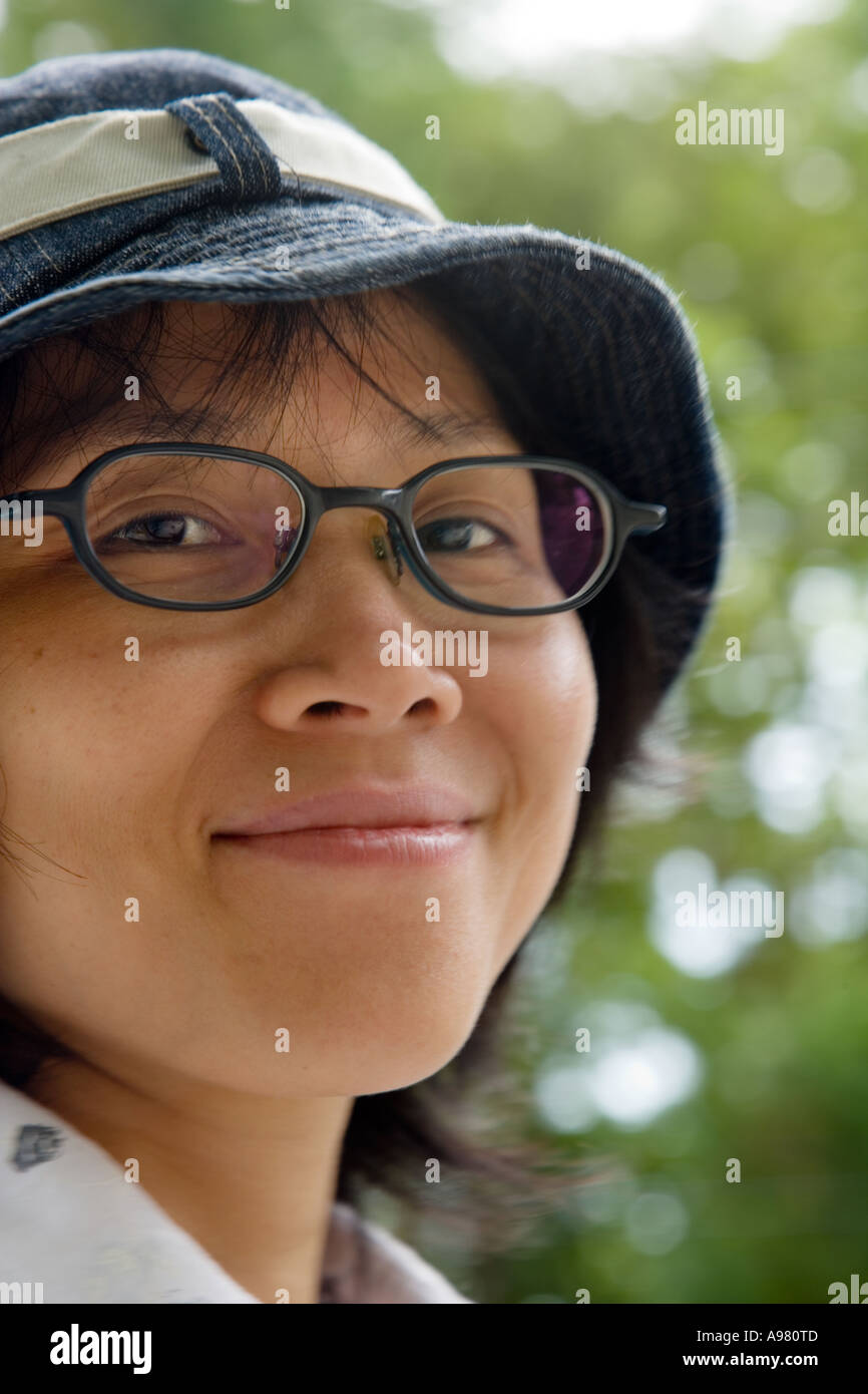 Happy, young Vietnamese woman with hat and glasses, Ho Chi Minh City
