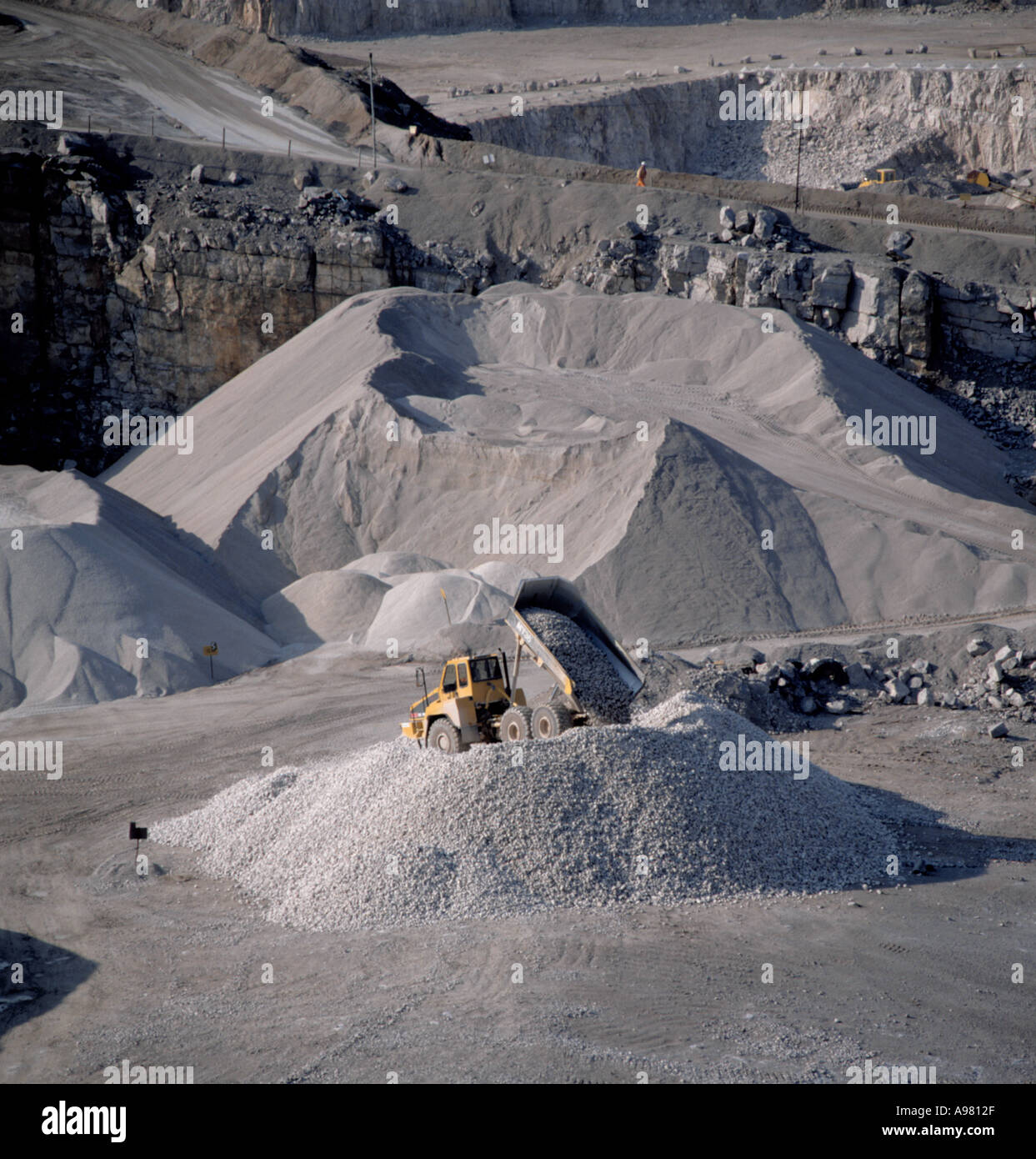 Dump truck tipping crushed limestone at Dene Quarry, Cromford, Peak