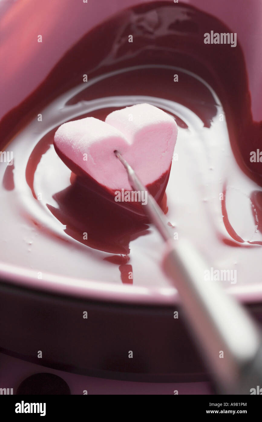 Chocolate fondue with heart shaped marshmallow FoodCollection Stock
