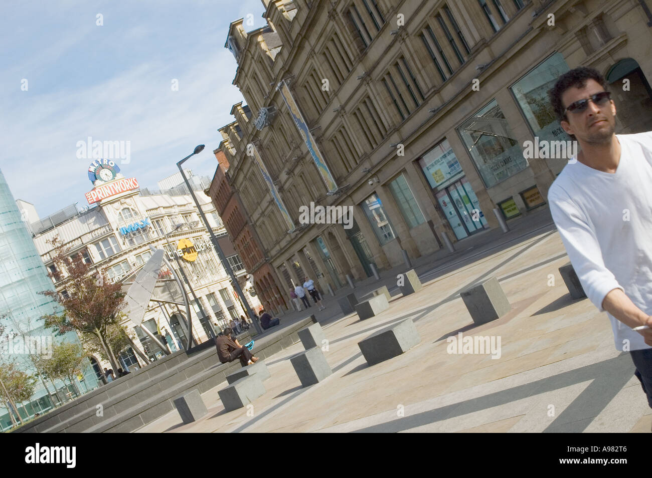 man walking in manchester city centre pushing pram Stock Photo