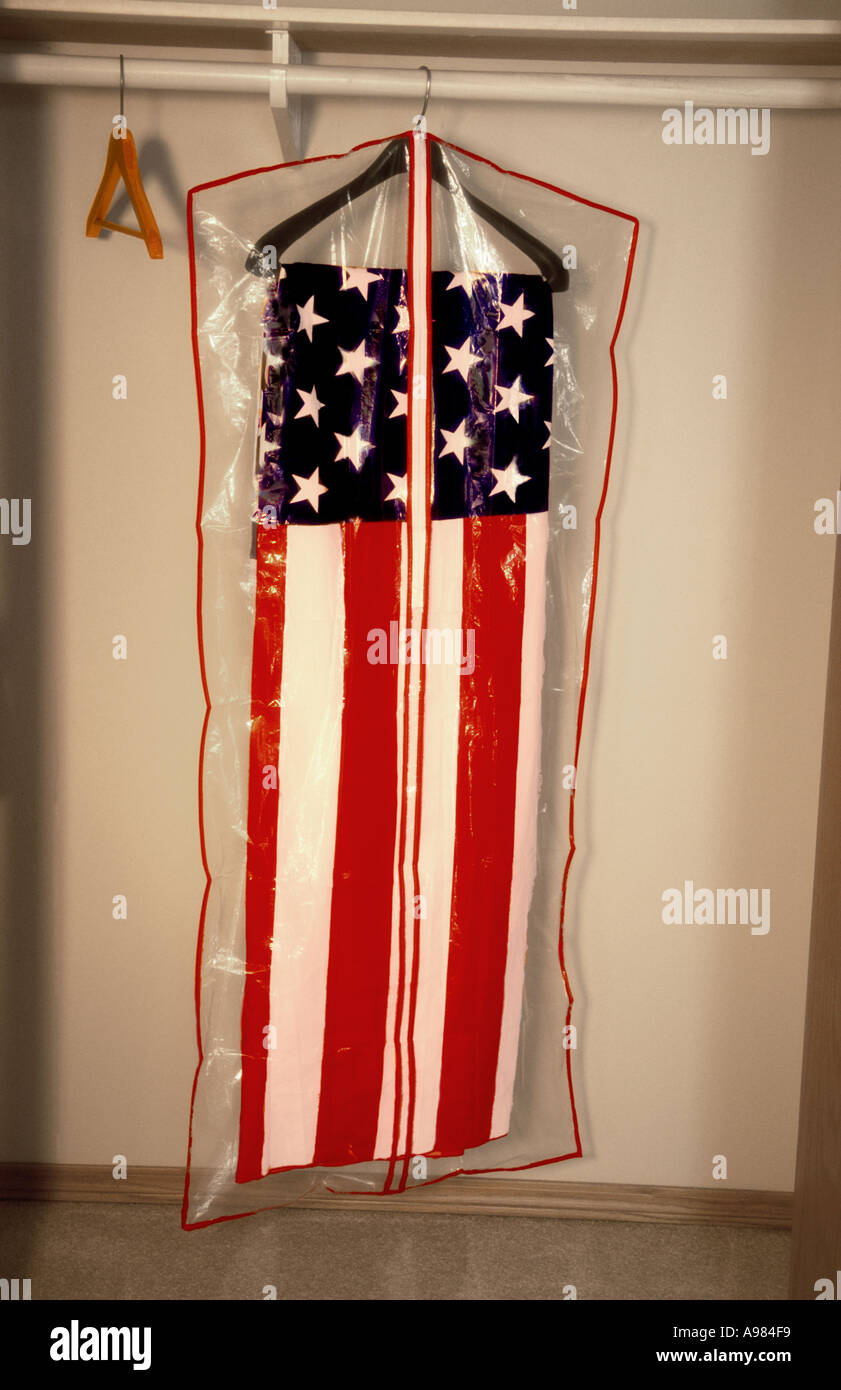 American flag wrapped in dry cleaner suit bag and stored in closet Stock Photo