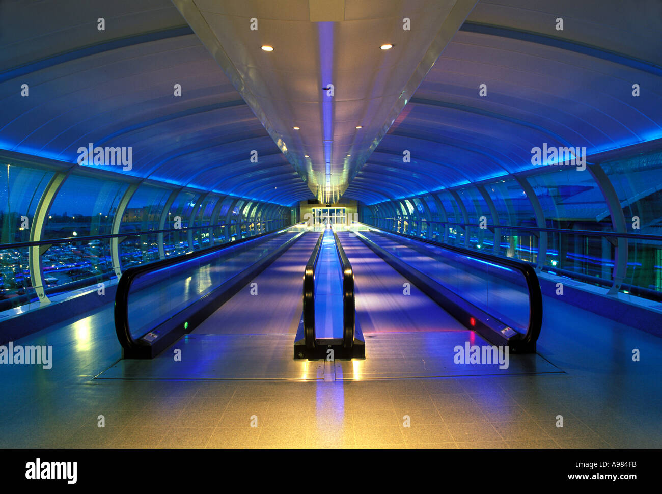 Passenger corridor and escalator at dawn between terminals 1 and 2 at Manchester Airport, UK Stock Photo