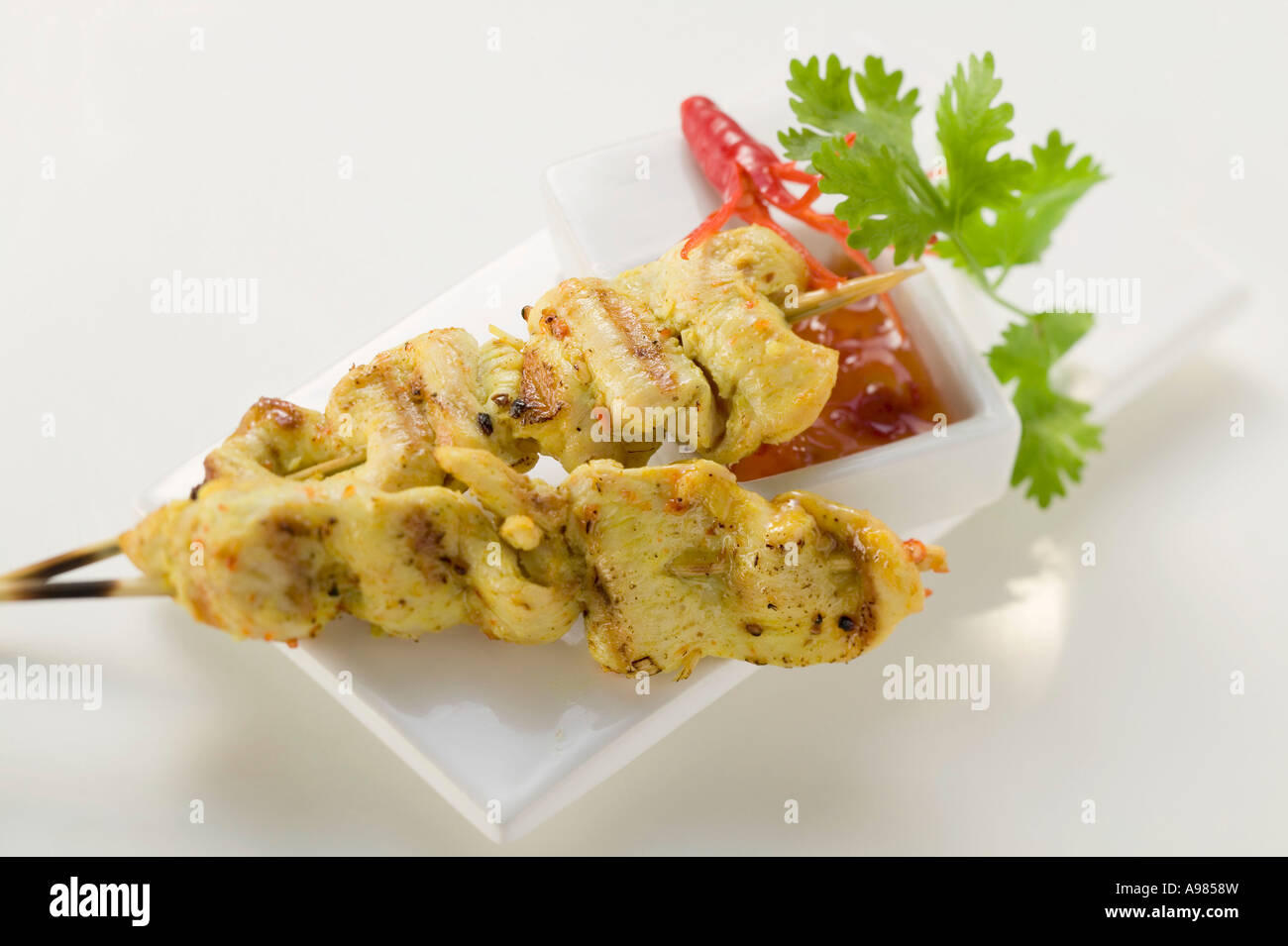 Spicy satay with sweet and sour chili sauce FoodCollection Stock Photo