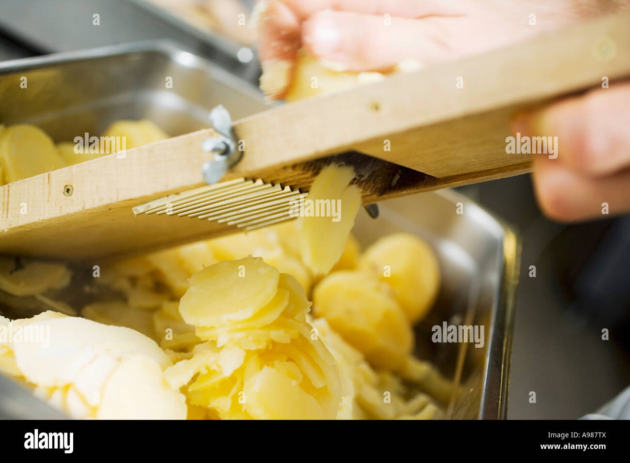 https://c8.alamy.com/comp/A987TX/slicer-cooked-potatoes-with-vegetable-slicer-foodcollection-A987TX.jpg