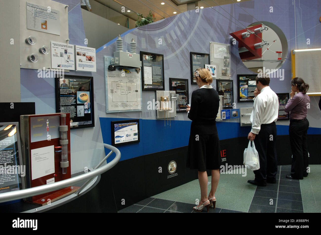 Attendees view invention trade show Stock Photo - Alamy